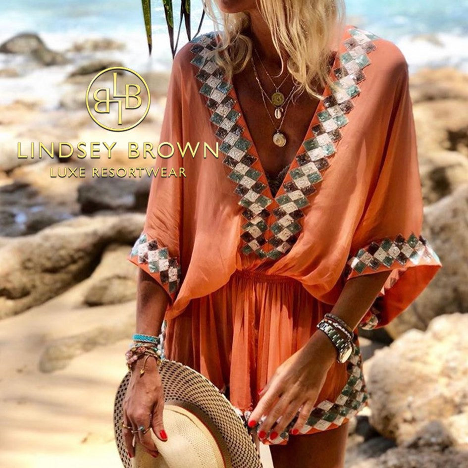 Anna Mavridis wears orange designer silk kaftan by Lindsey Brown resort wear