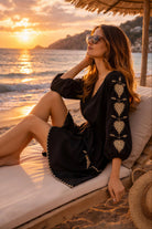 black cotton beach dress long sleeves to wear on cooler beach days by lindsey brown luxury resort wear 