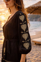 black cotton beach dress long sleeves with pretty gold embroidery to wear on cooler beach days by lindsey brown 
