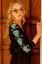 black cotton long sleeved beach dress with aqua embroidery by Lindsey Brown resort luxury wear 