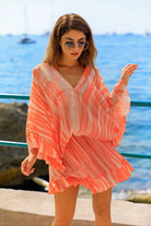 Orange v neck silk drop waisted kaftan dresses  by lindsey brown resort wear 