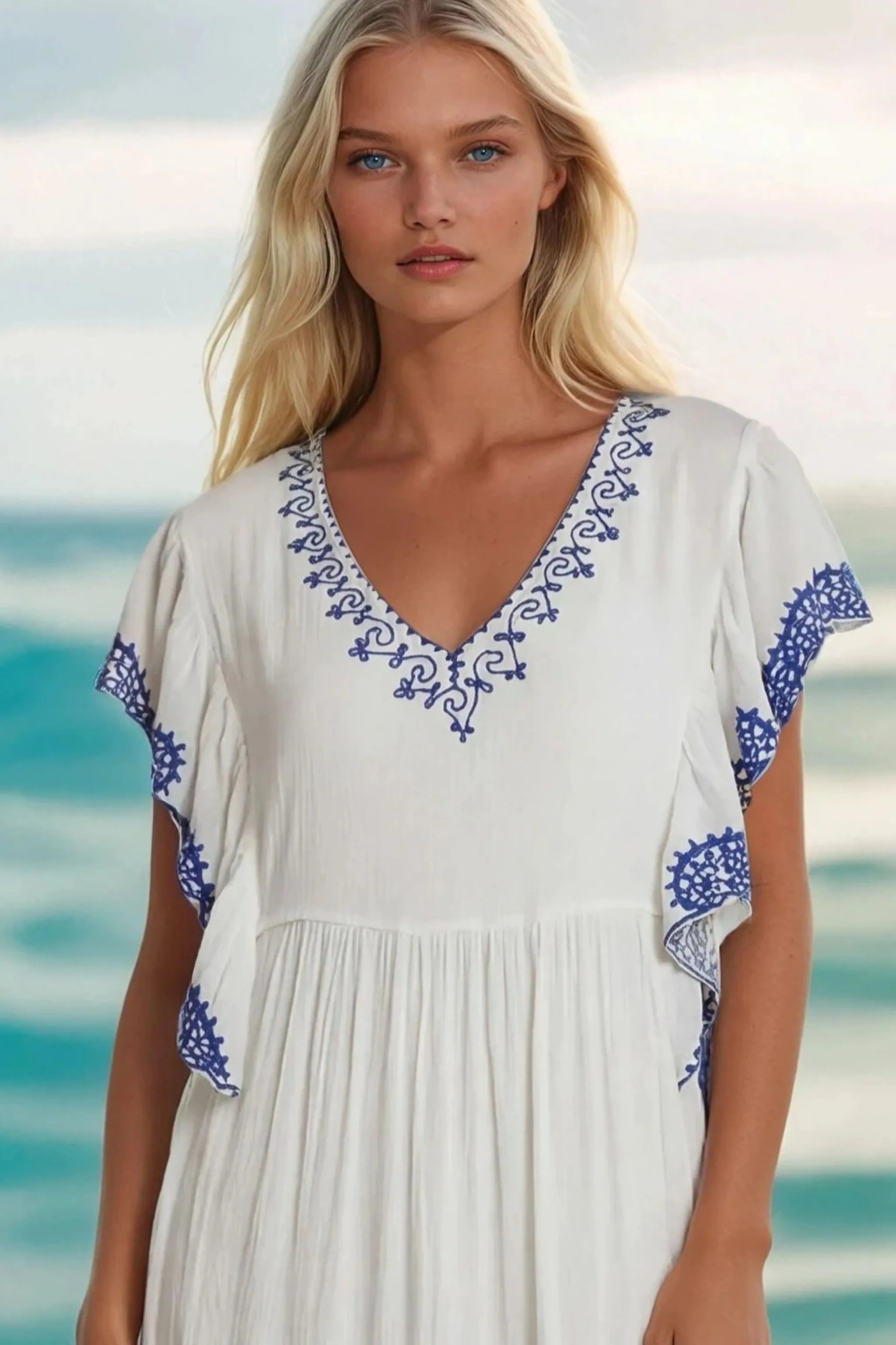White cotton midi dresses with blue embroidery to wear on warm holidays by Lindsey Brown