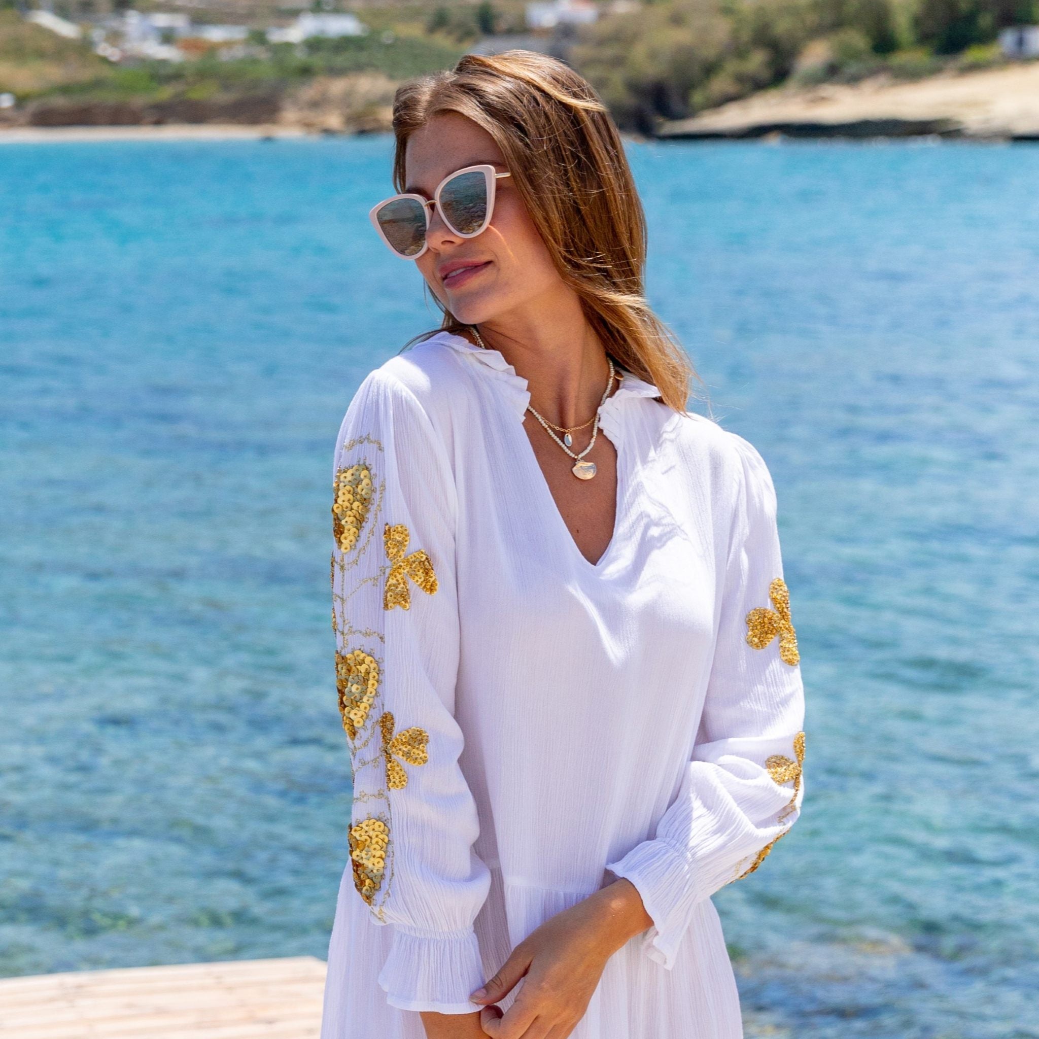 White and gold cotton beach dresses by Lindsey Brown