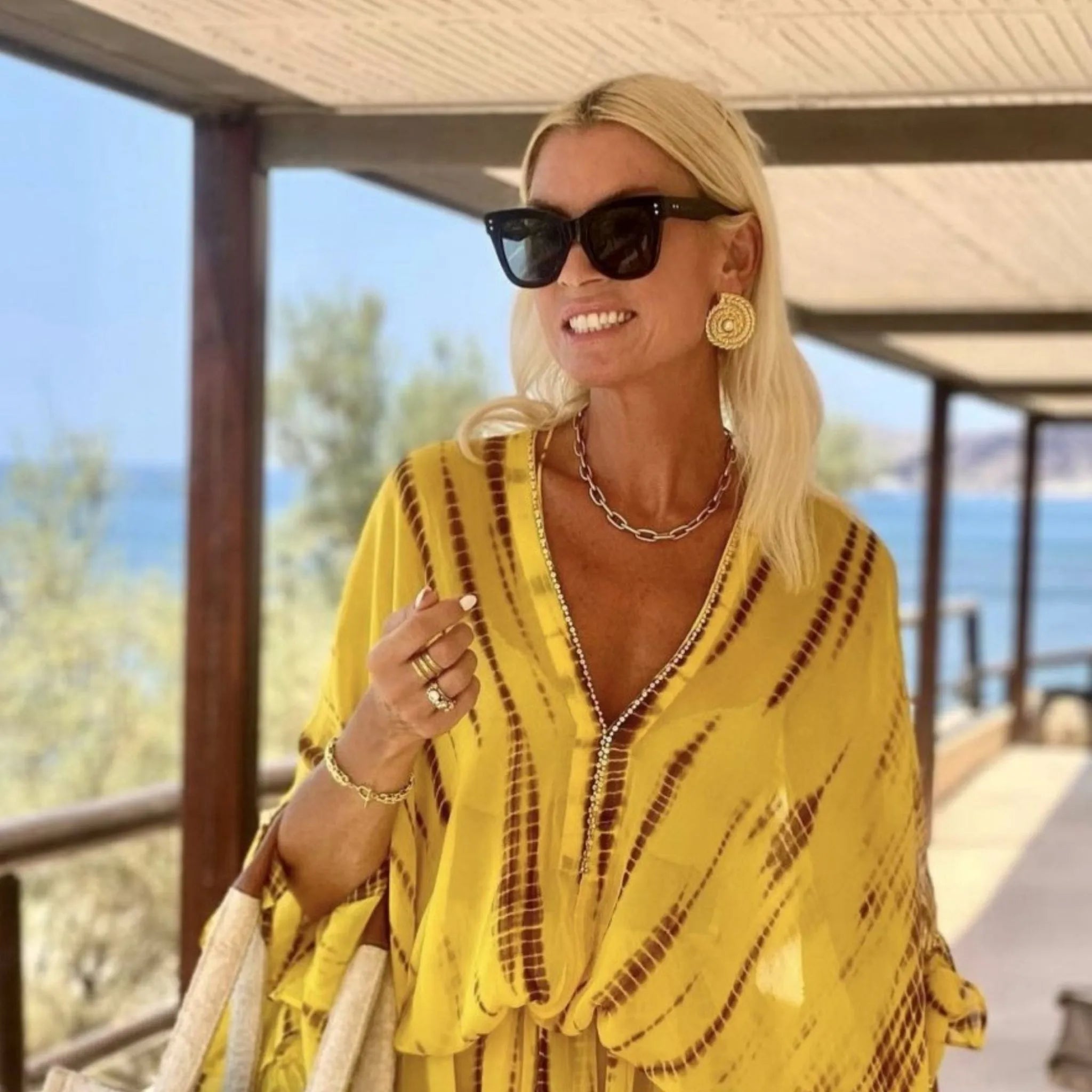 yellow silk designer kaftan dress to wear on a luxury holiday by Lindsey Brown resort wear
